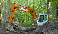 Excavator Peforming Land Clearing